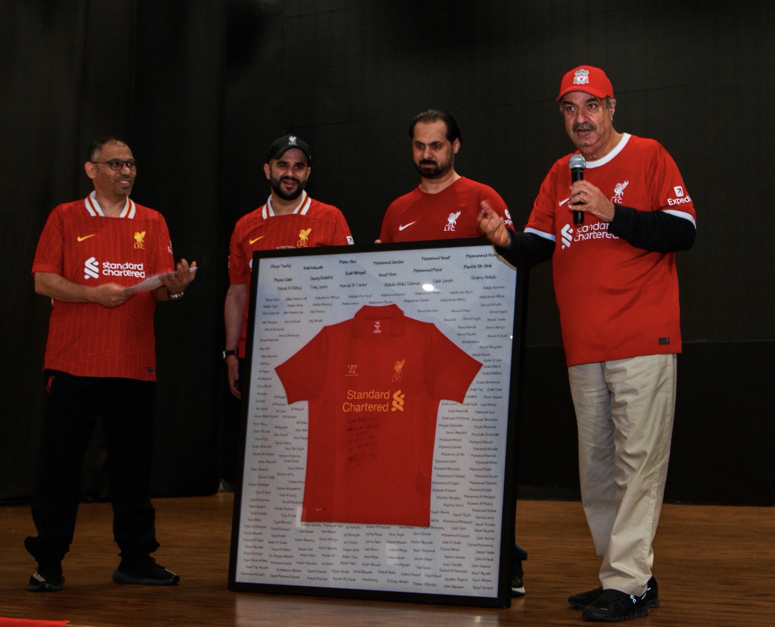 Dr Dheya Tawfiqi receiving the framed signed Steven Gerrard shirt