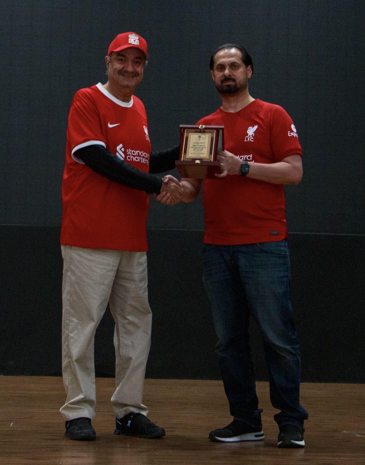 Dr Dheya Tawfiqi receiving a commemorative shield